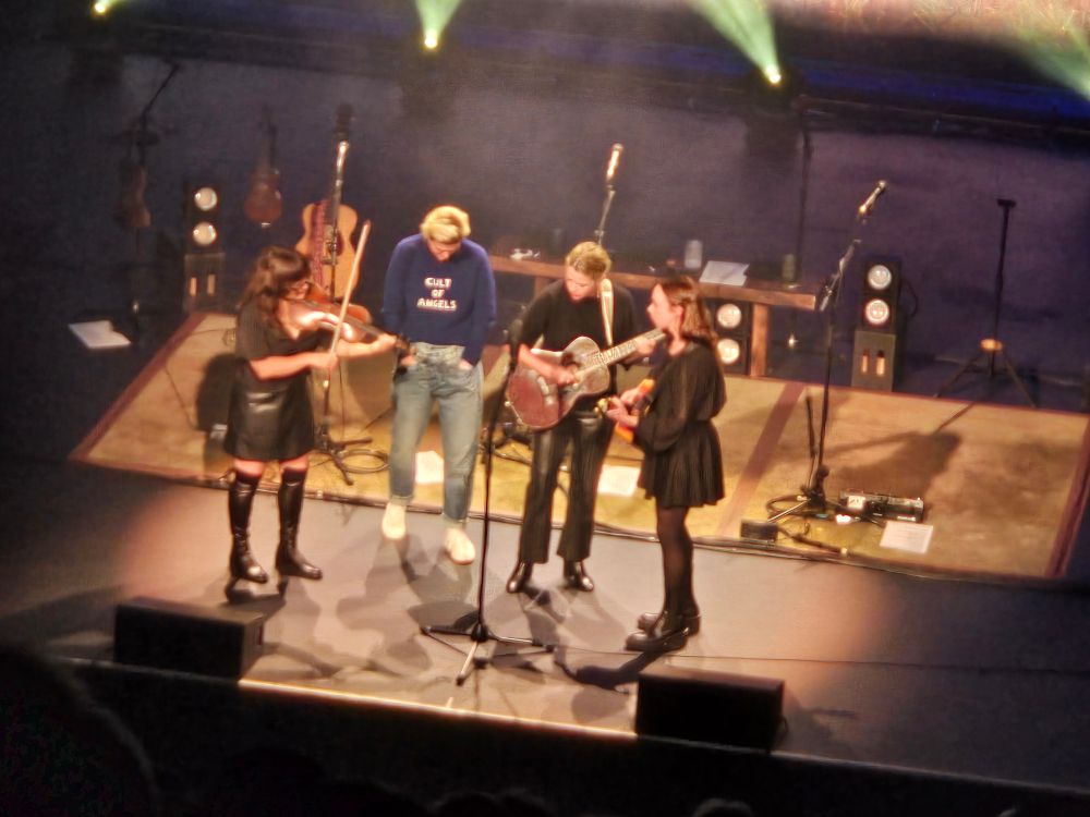 Brandi Carlile on the stage of the Moore Theatre, Seattle, with Aoife O'Donovan, Sarah Jarosz and Sarah Watkins of I'm With Her