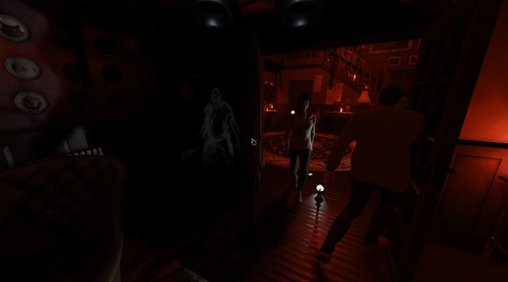 A screenshot of the game Phasmophobia. My teammate walks in through an open room door. A ghost has appeared behind the door and looks like it's about to jump out and yell BOO!