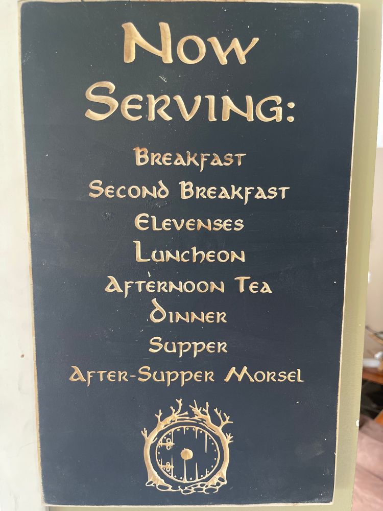 Lord of The Rings sign: Now serving - breakfast, elevenses, luncheon, afternoon tea, dinner, supper, after-supper morsel