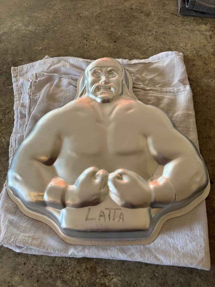 An aluminum cake pan shaped like hulk hogan flexing from the waist up. 