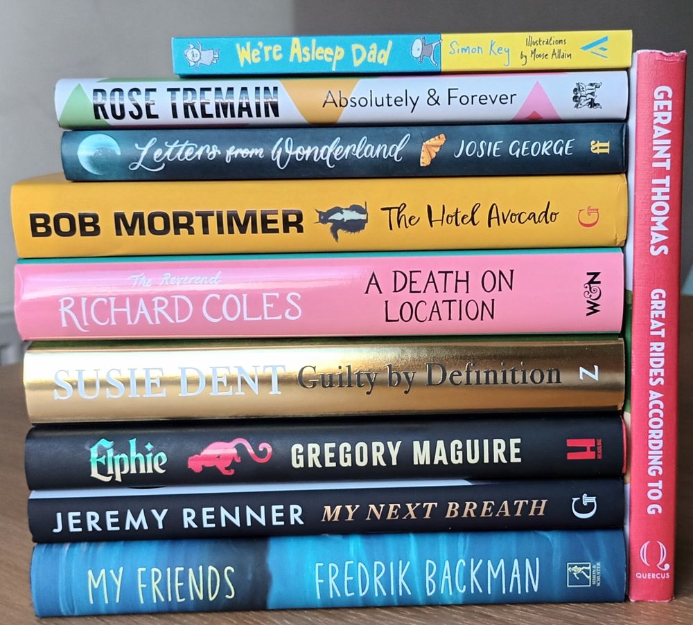A stack of hardback books (all signed), that you could win if you enter the raffle.