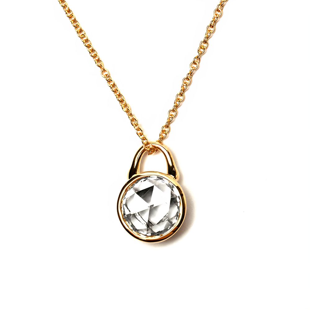 A rose cut lab grown diamond in a Roseate TreasureLock yellow gold setting against a pure white background. 