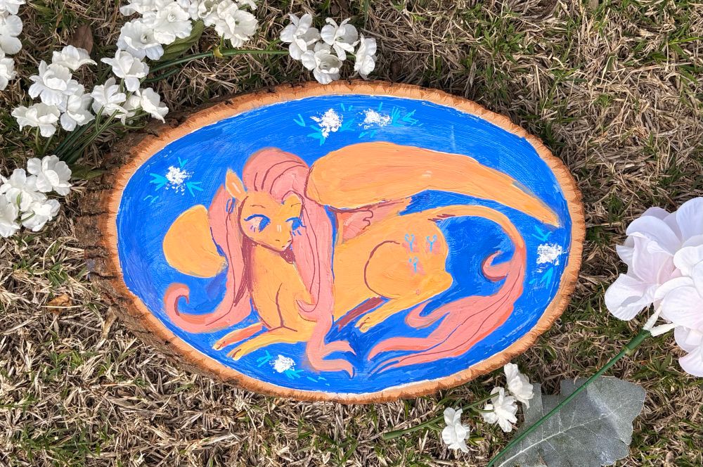 A painting of Fluttetshy surrounded by flowers 