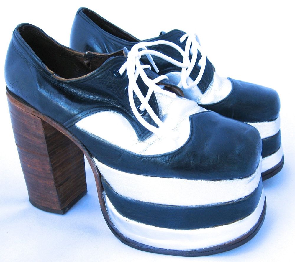 70s-era men's platform shoes, black and white leather with 4" soles in white/black/white layers and 6" brown heels.