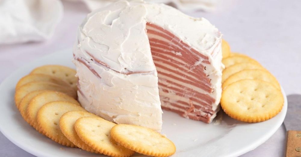 A bologna and cream cheese "cake" with a dozen layers of each, surrounded by Ritz crackers.