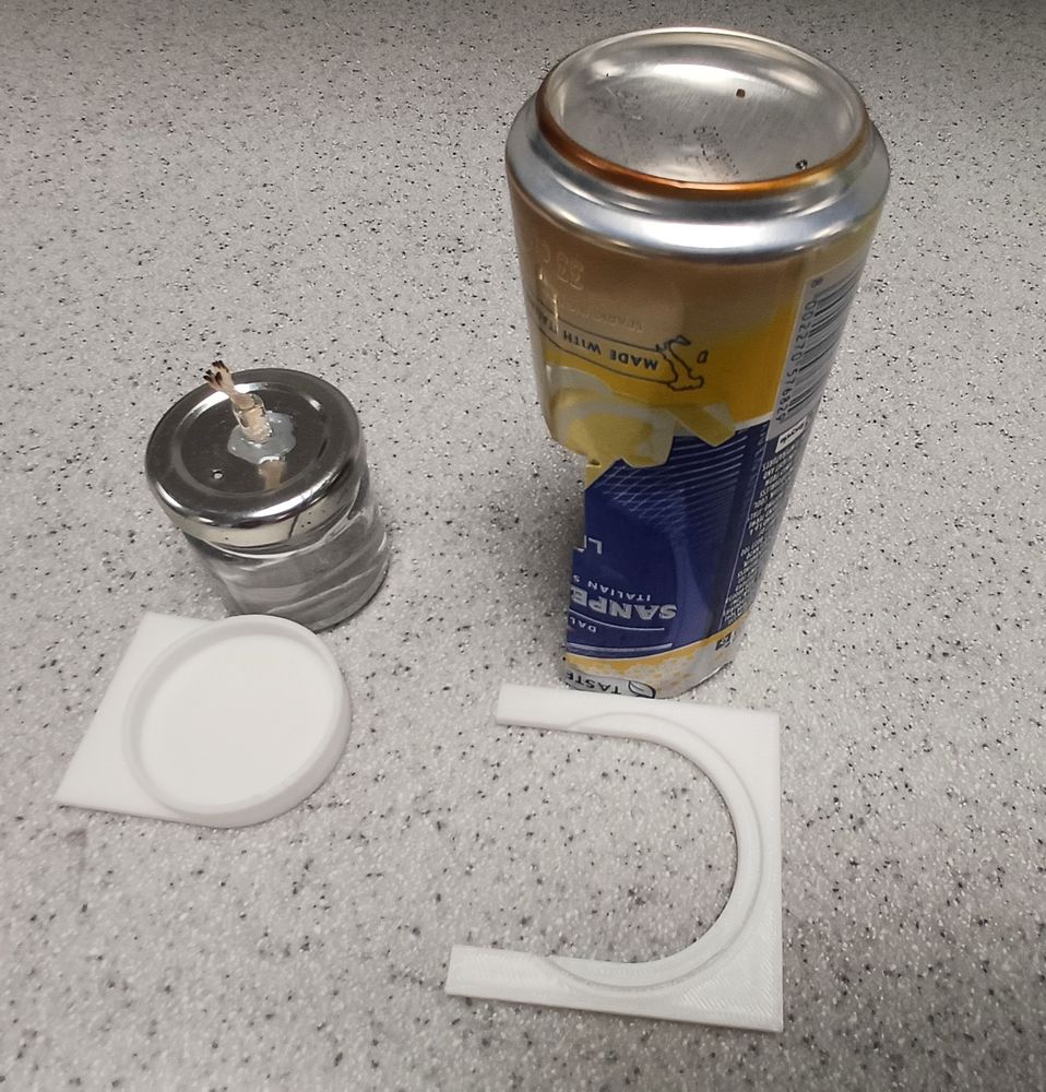 Ethanol fuelled spirit burner. The can is cut and sharp edges are folded over. 3D printed burner holder/slider and can-holder using the groove.