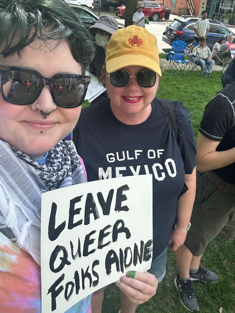 Selfie of me and my friend -my sign reads “leave queer folks alone”!