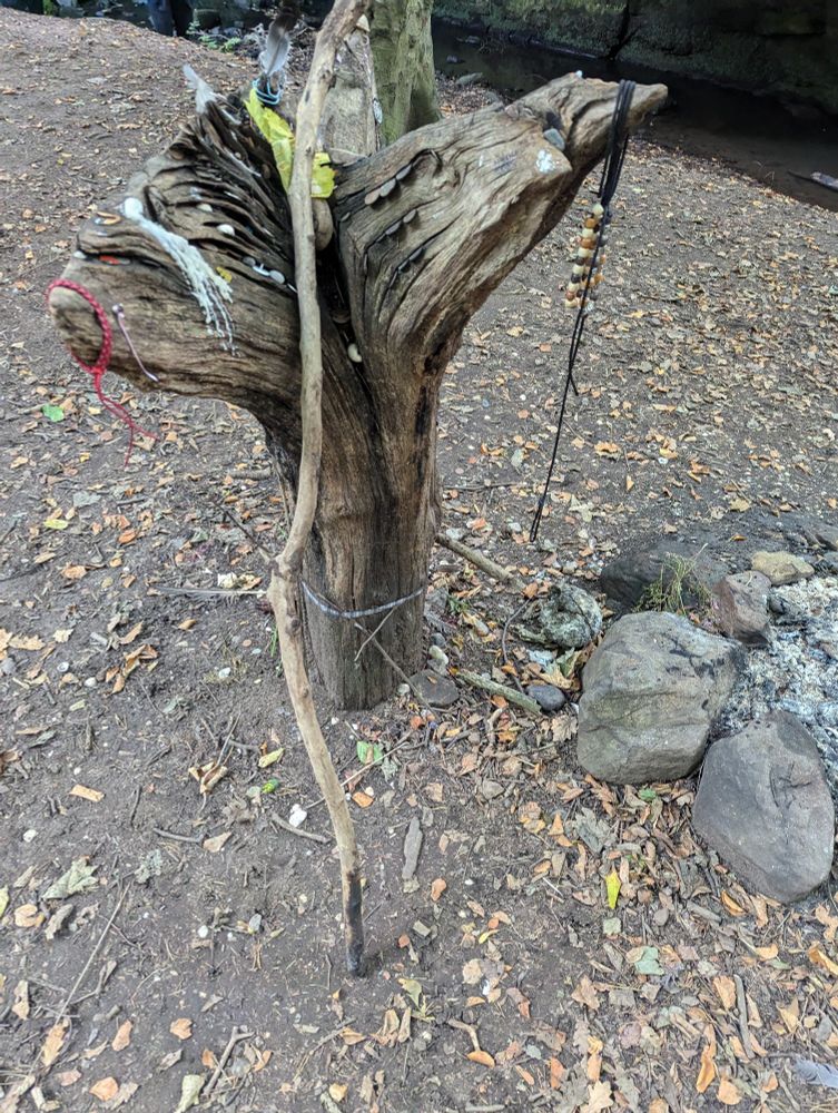 The alter from another side with a stick resting on it, probably for stoking the fire. 