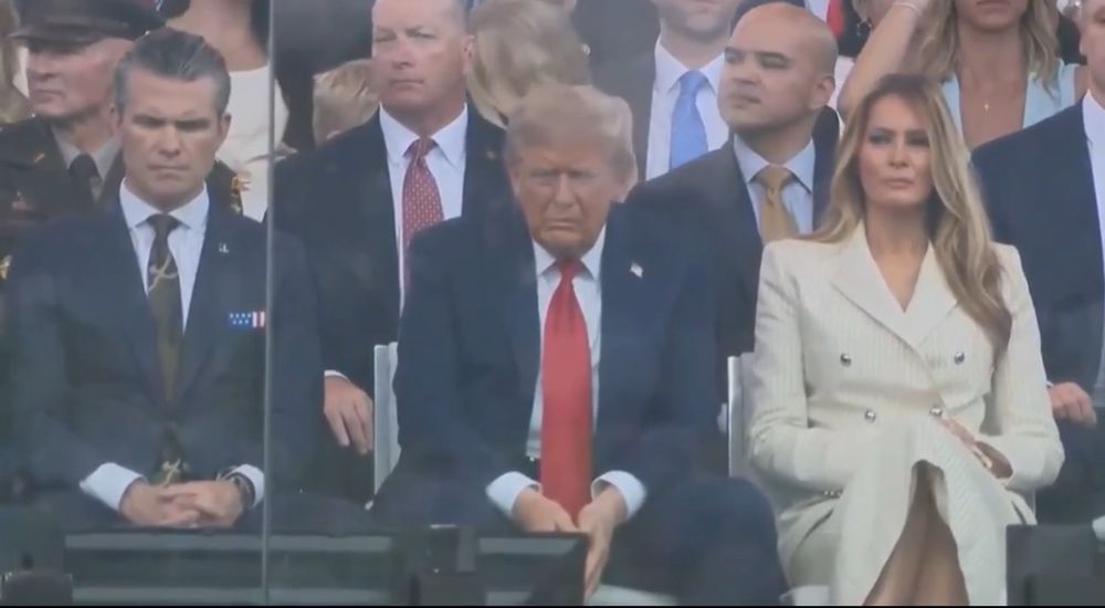 Sullen Trump watching his birthday perade 