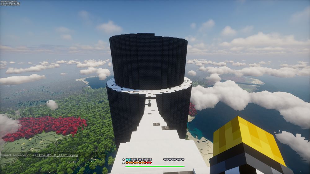 A view of the top of a giant tower in Minecraft. Behind it is a scenic view of the world.