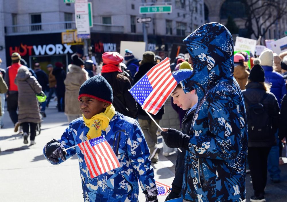 Children waving American flags at the protest march 