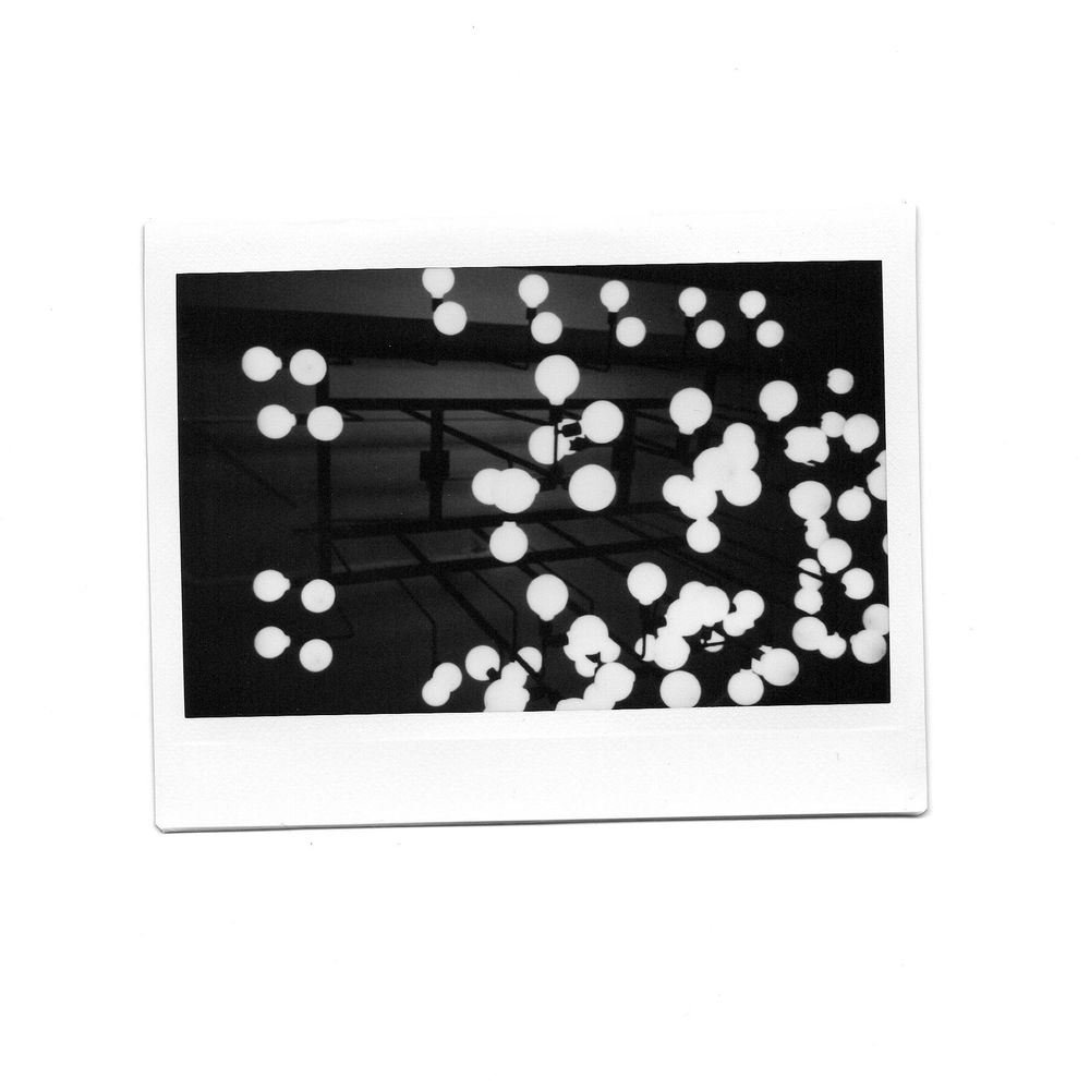Instax wide photo of an array of spherical light bulbs. 
