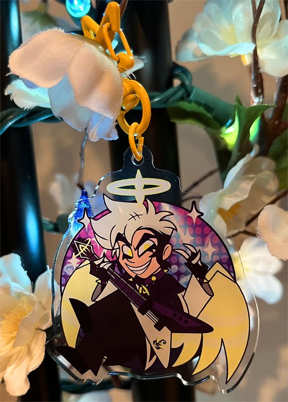 A keychain of an angel character playing a guitar.