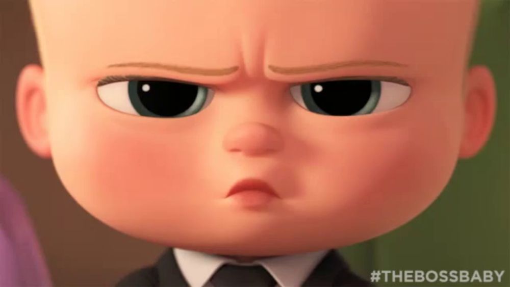 a close up of a baby from the boss baby making a funny face .