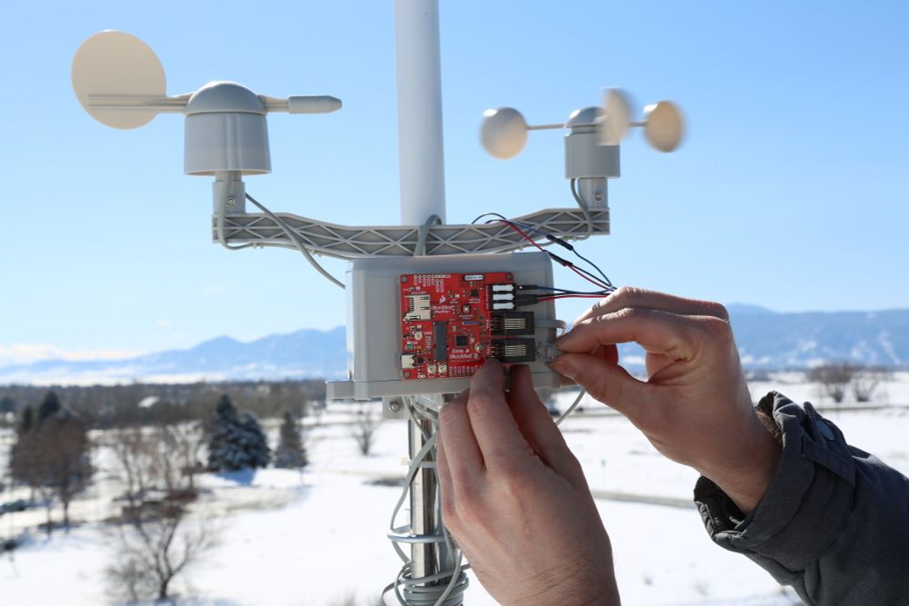 Weather monitor with environmental sensors with mountains and blue sky in background