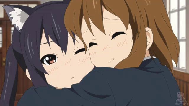 a couple of anime girls hugging each other with a fox logo in the corner