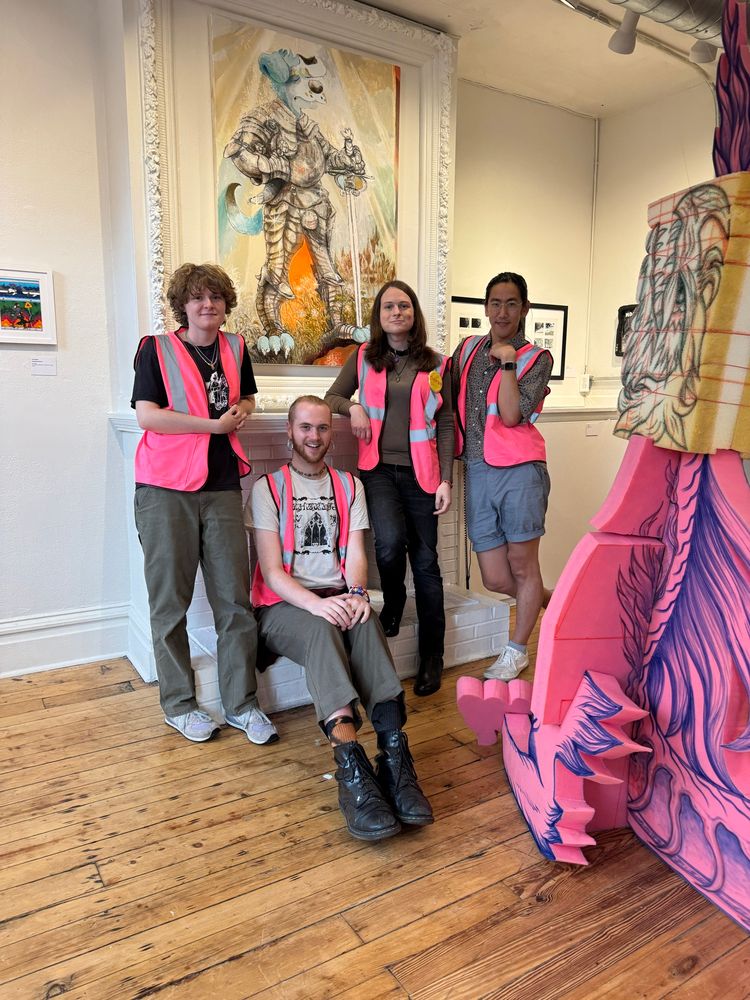 A photo of the Room Party team on the mantle in the gallery. From left to right: Lane, Cass, Brett and Paul.