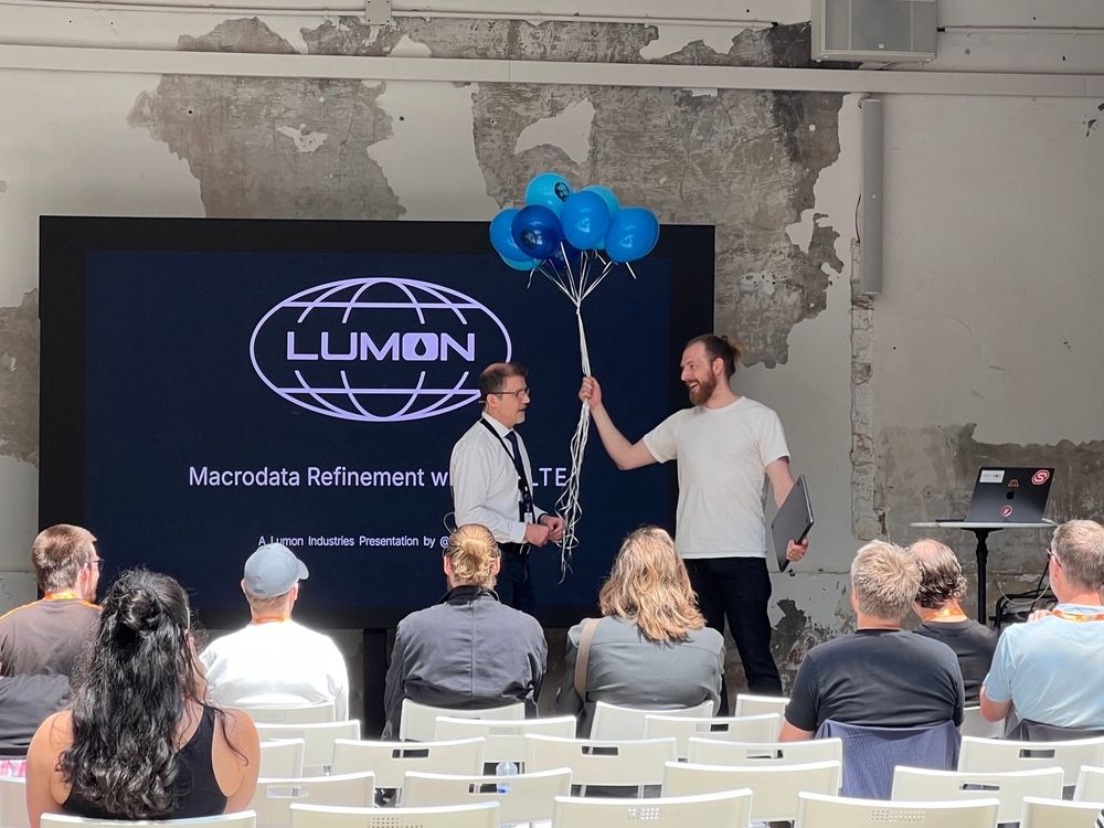 Rich Harris receiving bouquet of balloons from Lumon Industries on stage at Svelte Summit.