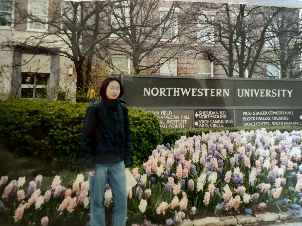 A female stands in front of a Northwestern University sign in 2000.