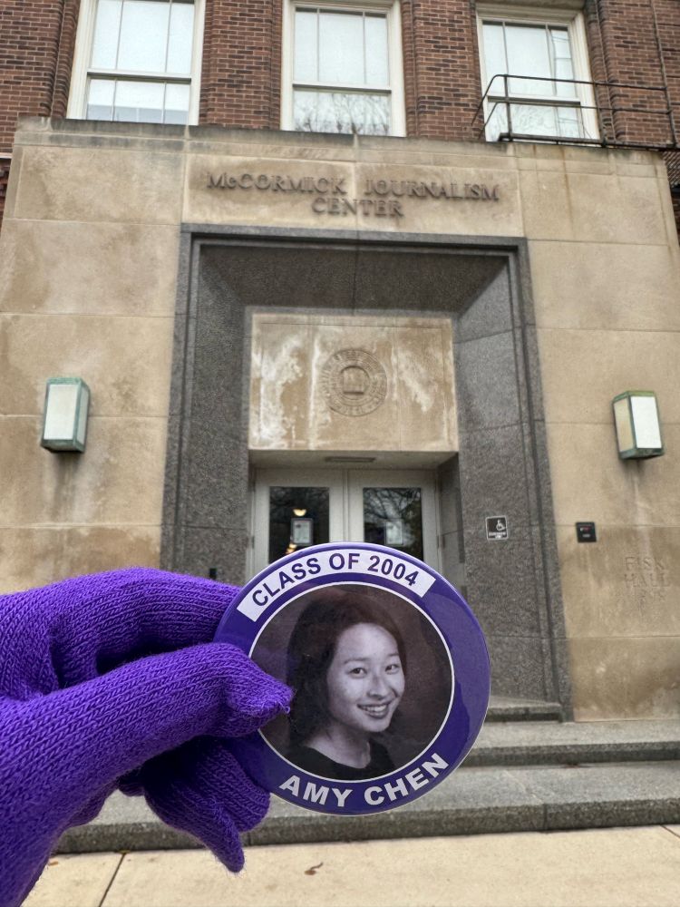 Holding a photo from 2004 in front of McCormick Journalism Center, Northwestern University 