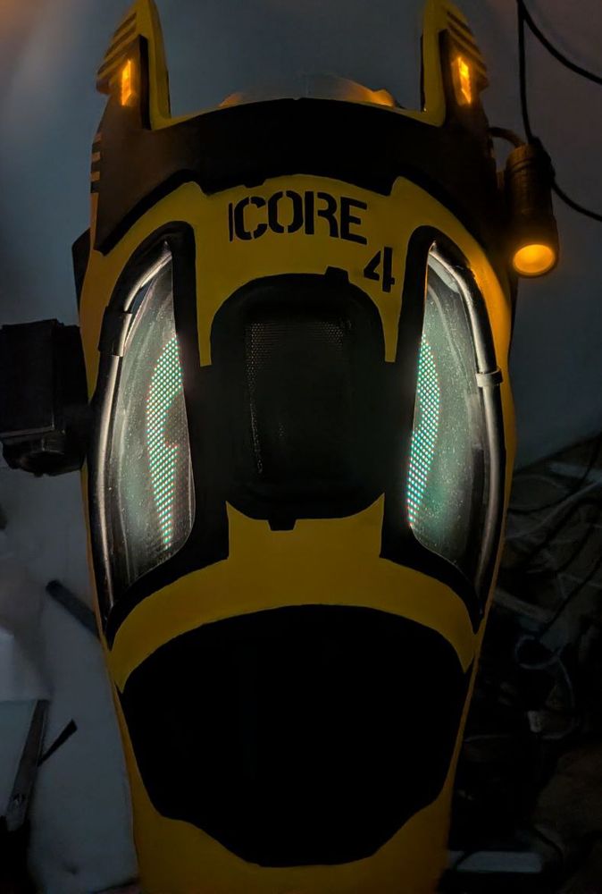 Synth partial head. Black and Yellow.
Ear lights and side torch lit up. As seen in a dark room.