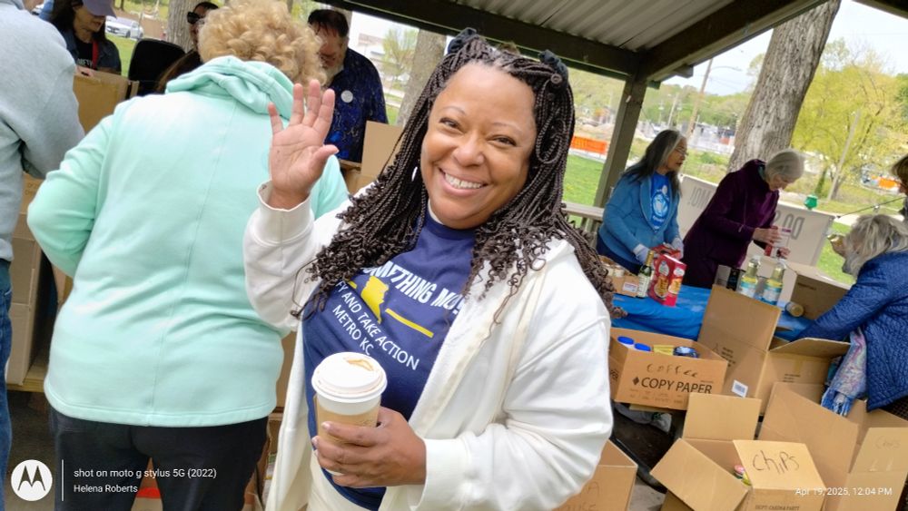 A happy volunteer staying warm while directing activities. 