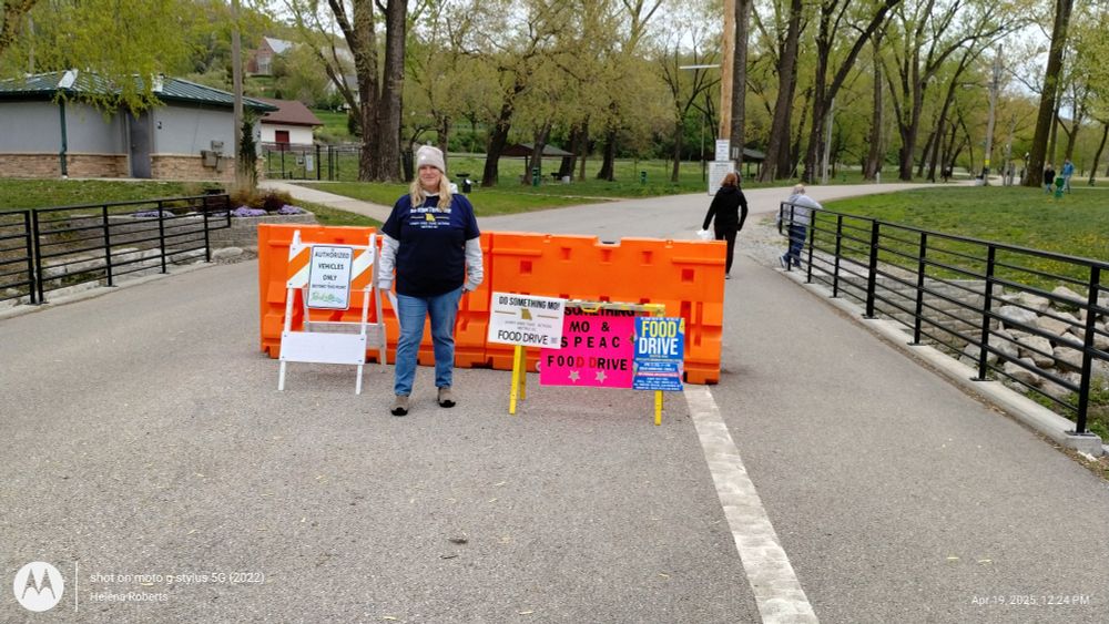 A volunteer directing traffic to the food drive