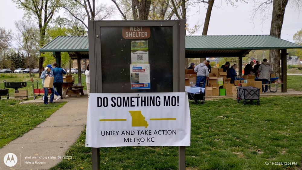A sign promoting the food drive in the park. 