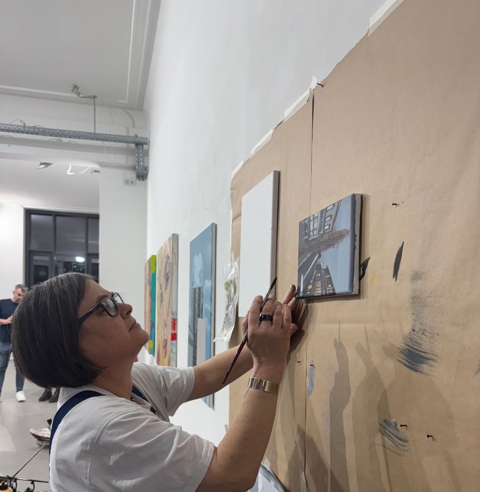 Several partially painted canvases hanging on a wall. I paint. 