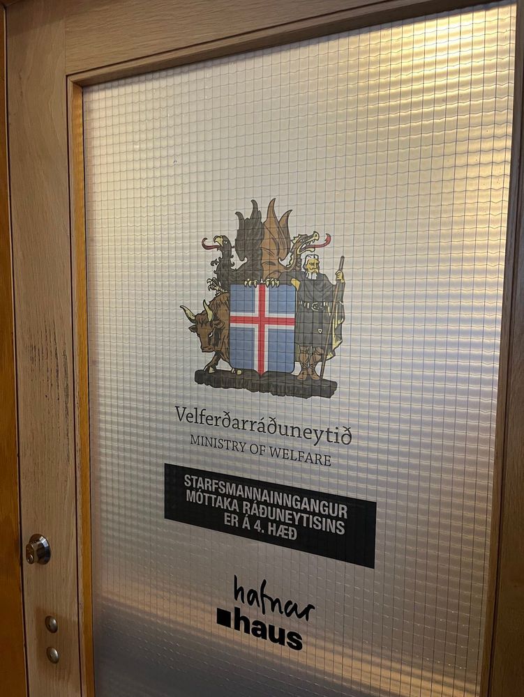 Door showing the original Icelandic Ministry of Welfare decals alongside Hafnar Haus branding