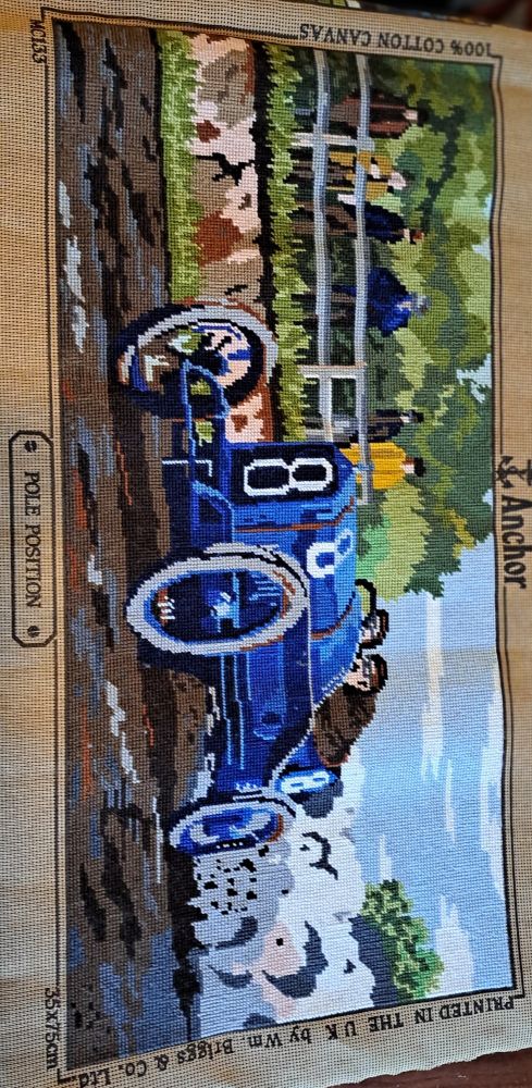 Completed tapestry, "Pole Position".
A 1920s racing car at speed, kicks up the dirt as it speeds past a group of spectators.

Tapestry wools from Anchor and DMC, a half cross-stitch is used on the printed canvas. 
