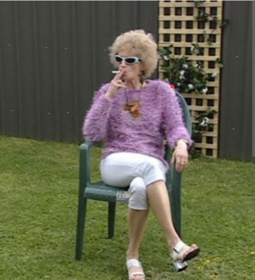 Kath from the TV Show Kath & Kim smoking in the garden