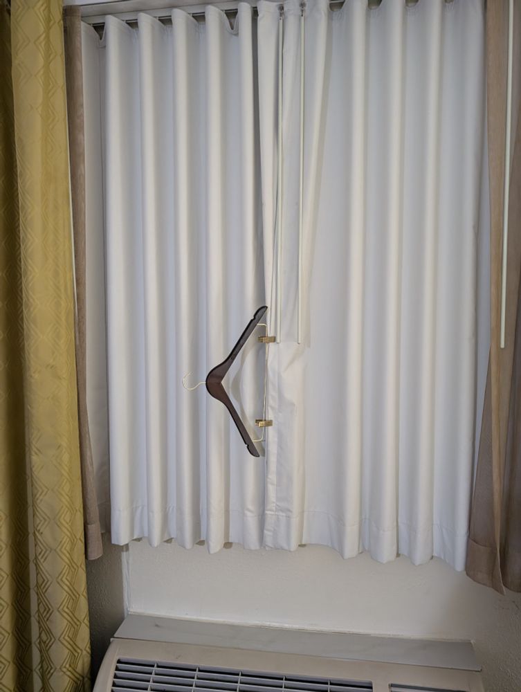 Clothes hanger clipping curtains closed
