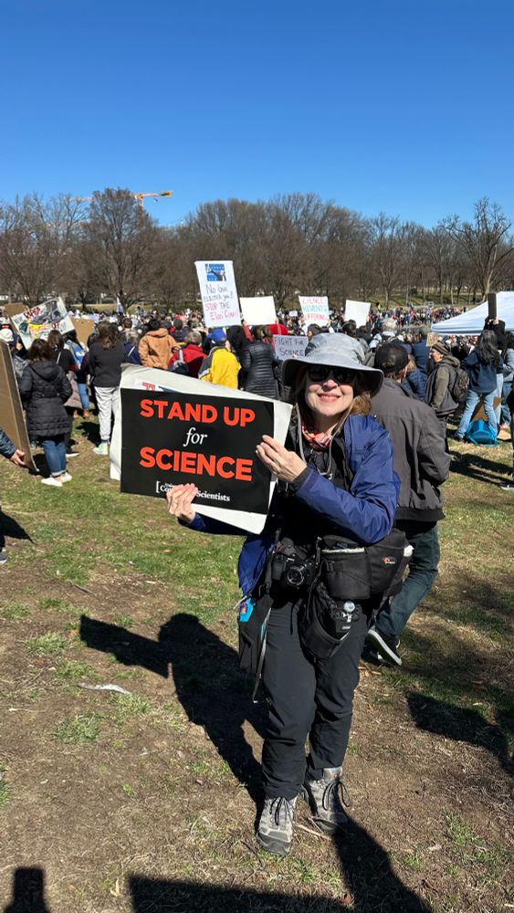 Woman holding a stand up for science sign