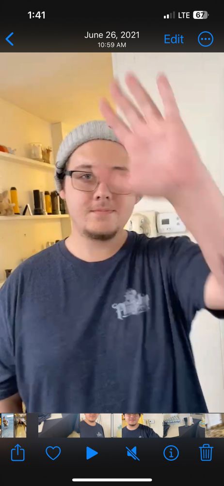 Young man smiling and waving at the camera 