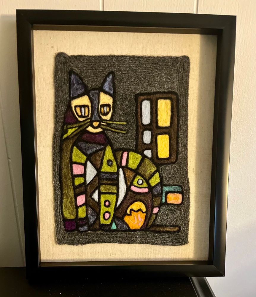 A cat in the cubist style made of felted wool 
