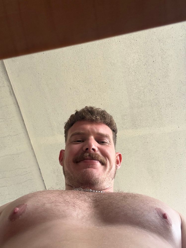 picture of me sitting with my nipples out looking back at the camera