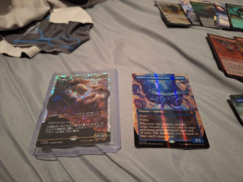 On the left is a Fracture Foil Japanese Progenitus.  On the right is a Mana Foil Sphinx of Forgotten Lore.
