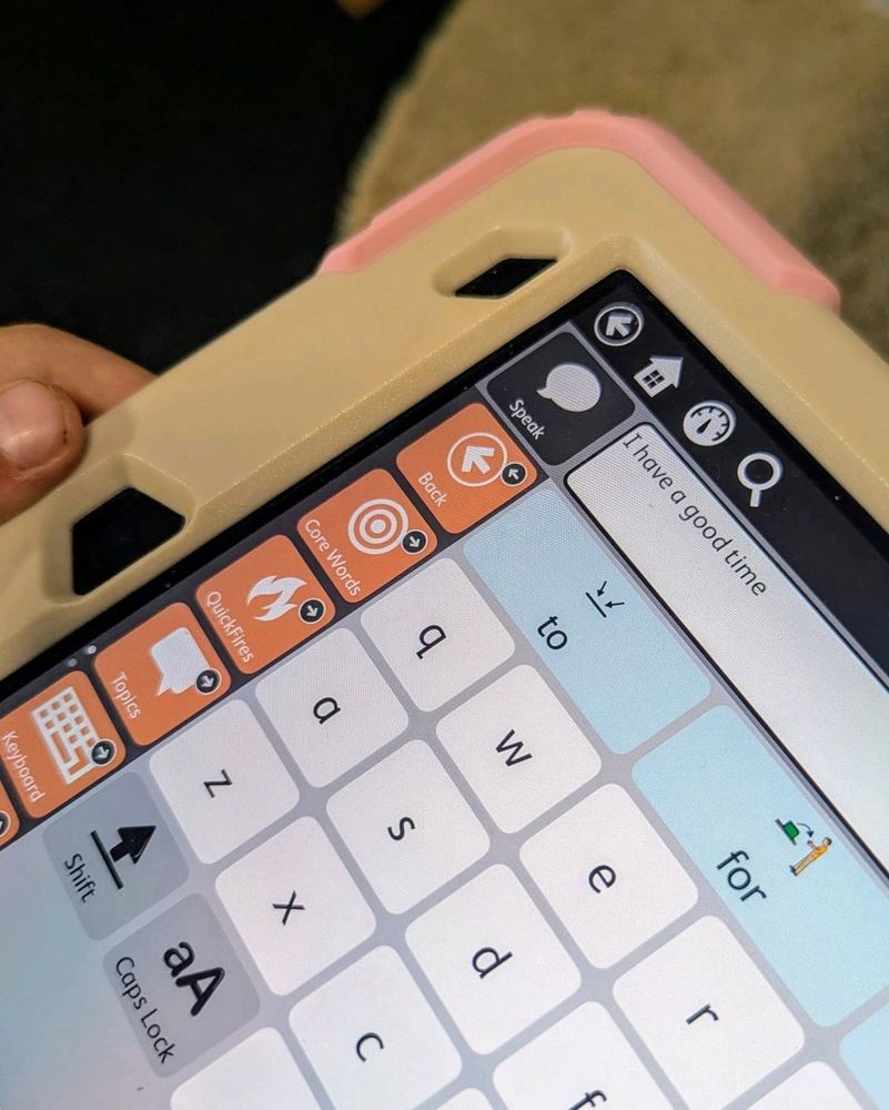 Photo of an iPad with the TD Snap communication app's keyboard displayed. The message window reads 'I have a good time.'