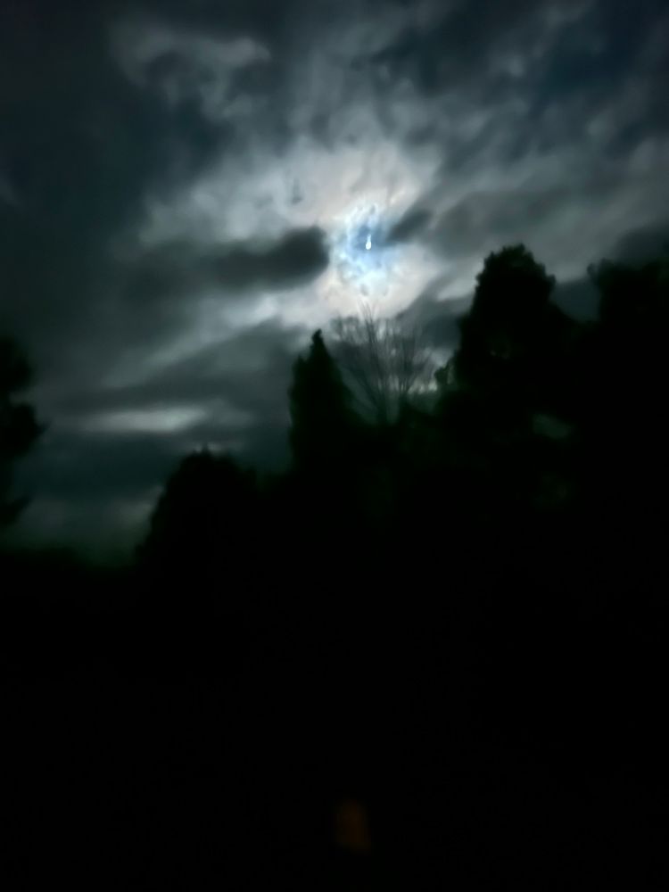 Photo from my yard of a half moon after  a heavy rain. Looks like fucking Minas Morgul 