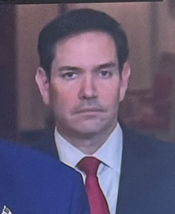 Marco Rubio standing behind Trump 