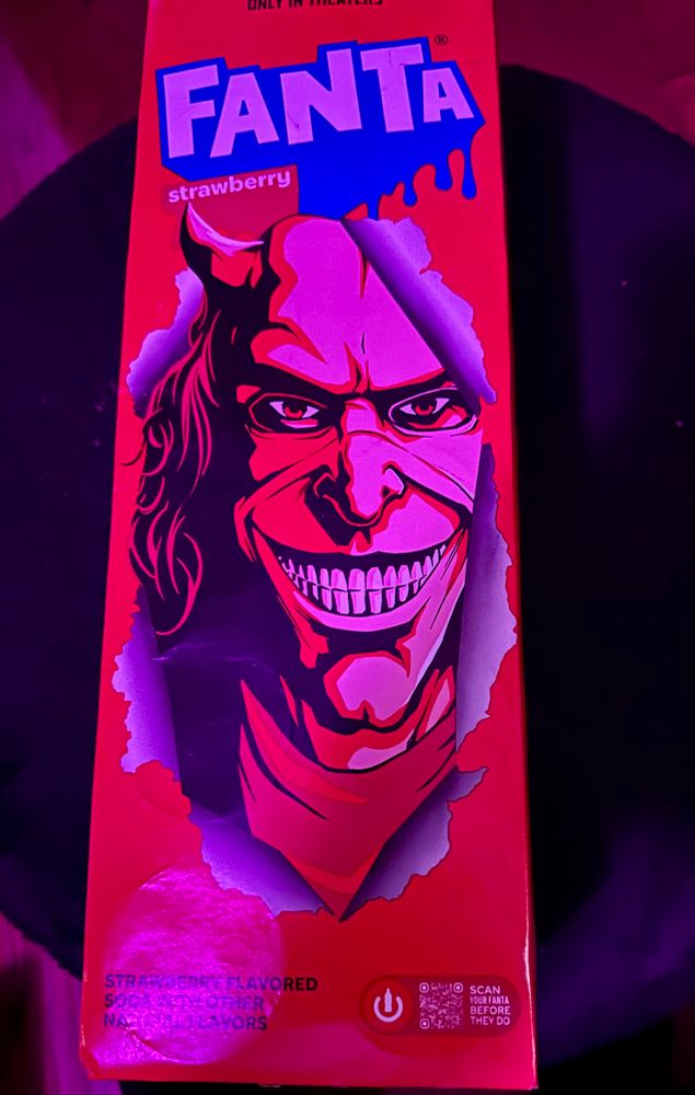 A 12 pack of Strawberry Fanta with an image of the Grabber from The Black Phone.