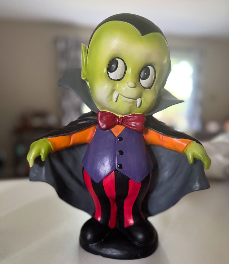 Creepy vampire boy statue. 