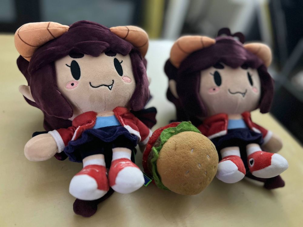 Two front facing Demilypuro plushies trying to take only one plush burger