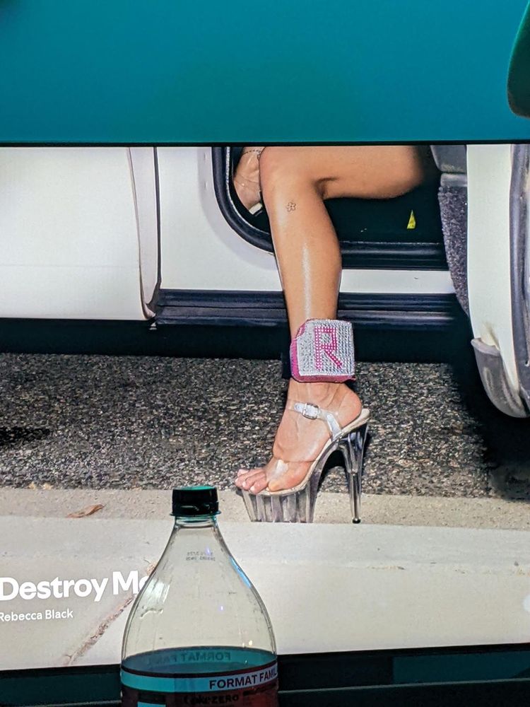 son image de couverte spotify c'est elle qui sort d'une voiture avec un gros plan sur son pied dans des chaussures à talon transparentes