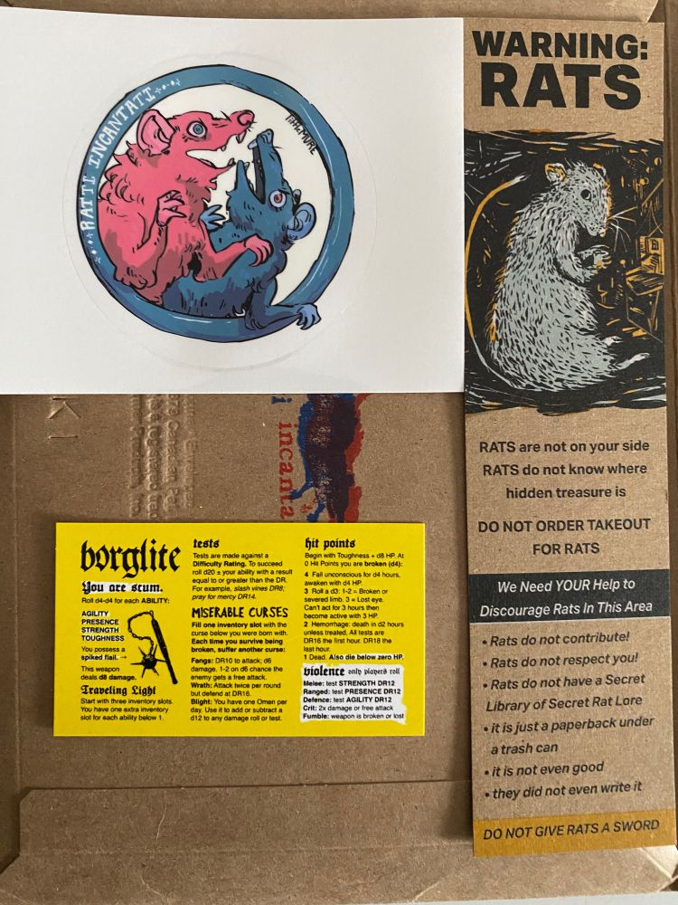 Ratti Incantati sticker and bookmark, and Borglite game on a business card. 