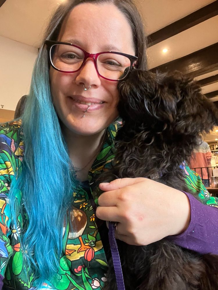 The puppy is trying to lick my face 