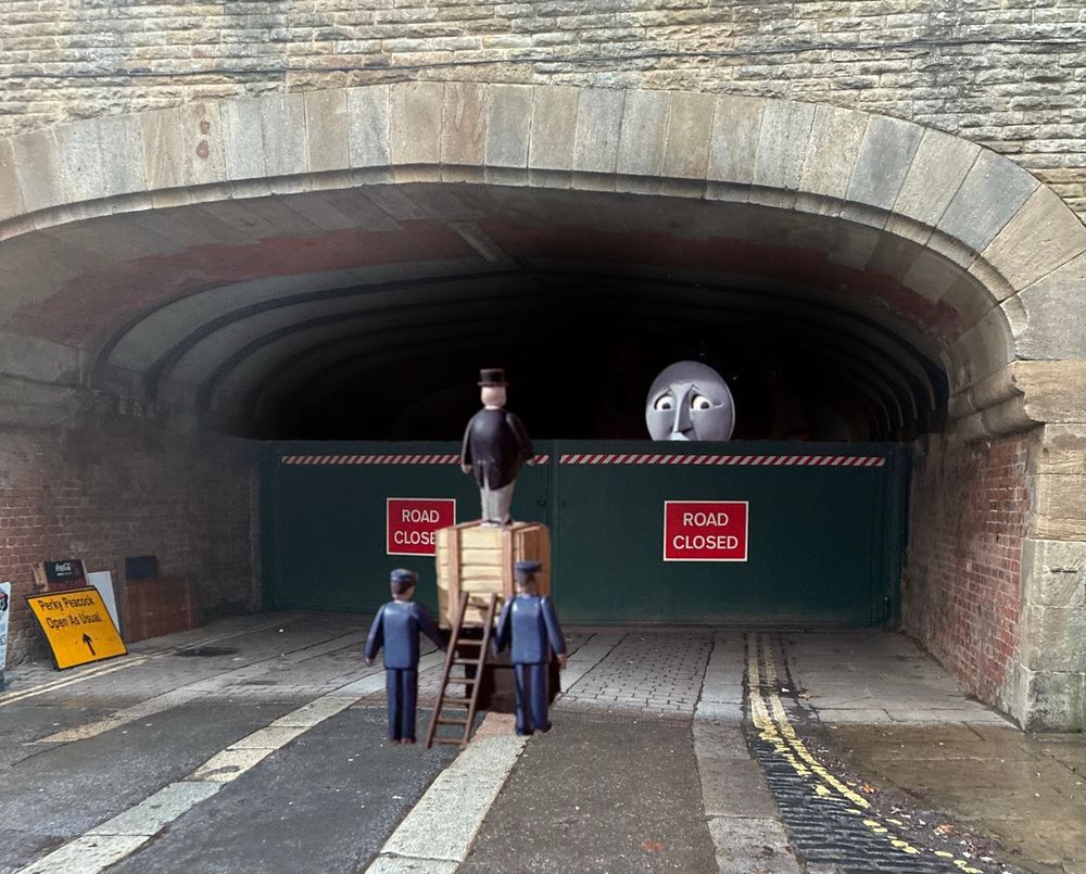 The above photo edited with the image from the old Thomas the Tank Engine TV series where Sir Topham-Hat goes full Cask-of-Amontillado and bricks Henry up in a tunnel and then he has to stand on a bunch of crates to talk to him. Henry looks forlorn in his dark tomb.