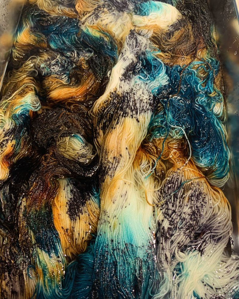 Yarn in water with a galaxy of colors 