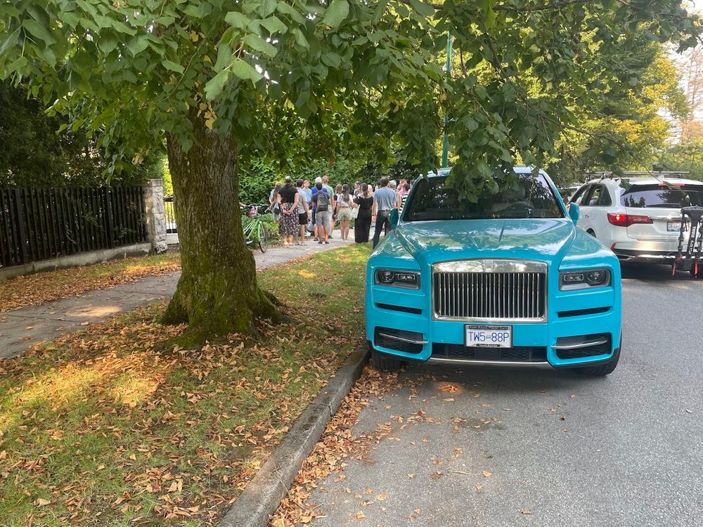 A baby-blue Rolls Royce SUV